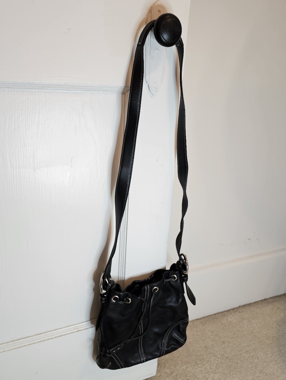 Coach Black leather crossbody bag with silver hardware and drawstring
